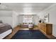 Spacious bedroom with hardwood floors, a seating area, and natural light at 5946 N New Jersey St, Indianapolis, IN 46220