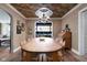 Formal dining room with a large wooden table, stylish wallpaper, wooden floors, and wainscoting at 5946 N New Jersey St, Indianapolis, IN 46220