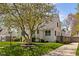 Charming white brick home featuring a well-manicured lawn and mature shade tree at 5946 N New Jersey St, Indianapolis, IN 46220