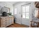 Bright foyer with decorative wallpaper, wood floors, chest of drawers and accent mirror at 5946 N New Jersey St, Indianapolis, IN 46220