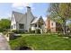 Charming white brick home with a gable roof, landscaped yard, and inviting covered front porch at 5946 N New Jersey St, Indianapolis, IN 46220