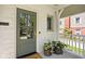 Inviting covered front porch with potted plants and a charming glass panel front door at 5946 N New Jersey St, Indianapolis, IN 46220