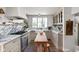 Charming kitchen featuring marble counters, wood floors, an apron front sink and stainless steel appliances at 5946 N New Jersey St, Indianapolis, IN 46220