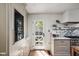 Bright, well-organized kitchen with stainless steel appliances, white cabinets, marble counter tops, and wooden floors at 5946 N New Jersey St, Indianapolis, IN 46220
