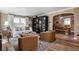Stylish living room featuring hardwood floors, a large bookcase, sofa, and decorative rug at 5946 N New Jersey St, Indianapolis, IN 46220