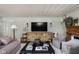 Inviting living room featuring a stone fireplace, wood accents, and comfortable seating at 5946 N New Jersey St, Indianapolis, IN 46220