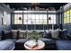 Comfortable living room with a cozy, cushioned window seat, dark blue walls and dark built-in shelving at 5946 N New Jersey St, Indianapolis, IN 46220