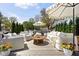 Outdoor patio with comfortable seating, umbrellas, and a lovely garden view at 5946 N New Jersey St, Indianapolis, IN 46220