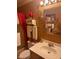 Bathroom featuring a vanity with white sink, etched mirror, and decorative gold hardware at 6040 Ipswich Ct, Indianapolis, IN 46254