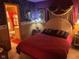 Cozy bedroom featuring a plush bed with decorative pillows, soft lighting, and an ensuite bathroom at 6040 Ipswich Ct, Indianapolis, IN 46254