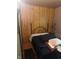 Bedroom showcases wood paneling and a wrought iron bed frame at 6040 Ipswich Ct, Indianapolis, IN 46254