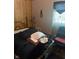 This bedroom showcases a bed with wood paneling, and comfortable seating at 6040 Ipswich Ct, Indianapolis, IN 46254