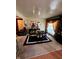 Elegant dining room with a black table set for a formal meal, adjacent to a cozy living space at 6040 Ipswich Ct, Indianapolis, IN 46254