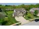 Aerial view of a home with a well-maintained lawn and a three car garage at 6054 Easy Ln, Indianapolis, IN 46259