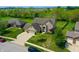 Aerial view of a home with a well-maintained lawn and a three car garage at 6054 Easy Ln, Indianapolis, IN 46259