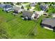 Aerial view of a home showcasing its large backyard, screened-in porch, and beautiful landscaping at 6054 Easy Ln, Indianapolis, IN 46259