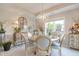 Cozy dining room features elegant chandelier, stylish furnishings, and bright natural light from the window at 6054 Easy Ln, Indianapolis, IN 46259
