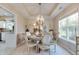 Elegant dining room features decorative lighting, tray ceiling, neutral tones, large window with natural light at 6054 Easy Ln, Indianapolis, IN 46259