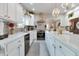 Bright, open kitchen boasts white cabinets, stainless appliances, stylish backsplash, and large island with quartz countertops at 6054 Easy Ln, Indianapolis, IN 46259