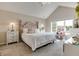 Bright main bedroom featuring vaulted ceiling, neutral tones, a decorative headboard, and a window seat at 6054 Easy Ln, Indianapolis, IN 46259