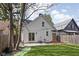 Charming backyard featuring a patio with sliding glass doors, green grass, and string lights at 611 Tecumseh St, Indianapolis, IN 46201
