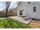 Backyard featuring a concrete patio and a well-maintained lawn with mature trees at 611 Tecumseh St, Indianapolis, IN 46201