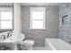 Stylish bathroom featuring a modern vanity, sleek fixtures, and a bathtub with tiled walls at 611 Tecumseh St, Indianapolis, IN 46201