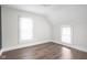 Empty bedroom featuring neutral paint, hardwood floors, and natural light from two windows at 611 Tecumseh St, Indianapolis, IN 46201