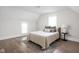 Bedroom with neutral décor, hardwood floors, and natural light; featuring a bed with accent pillows at 611 Tecumseh St, Indianapolis, IN 46201
