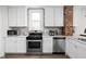 Bright kitchen with stainless steel appliances and ample countertop space at 611 Tecumseh St, Indianapolis, IN 46201