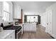 Bright kitchen featuring modern white cabinets, stainless steel appliances, and hardwood floors open to living area at 611 Tecumseh St, Indianapolis, IN 46201
