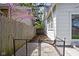 A narrow side yard is enclosed by a wooden fence and a charming garden with a small fence at 611 Tecumseh St, Indianapolis, IN 46201