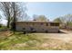 Large backyard with basketball court and stone home in background at 614 Debra Ln, Indianapolis, IN 46217