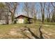 Spacious backyard with trees, a shed, and green grass at 614 Debra Ln, Indianapolis, IN 46217