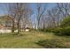 Huge backyard featuring large trees with a grassy lawn and outbuilding at 614 Debra Ln, Indianapolis, IN 46217
