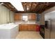 Basement laundry area and kitchen featuring updated appliances and ample storage at 614 Debra Ln, Indianapolis, IN 46217