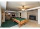 Finished basement featuring a pool table, carpet, and a cozy fireplace for added warmth at 614 Debra Ln, Indianapolis, IN 46217