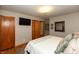 Comfortable bedroom features a queen bed, wood floors, closet, and natural light from the windows at 614 Debra Ln, Indianapolis, IN 46217