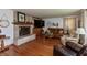 Spacious living room boasts a stone fireplace, hardwood flooring, and comfortable seating for relaxation at 614 Debra Ln, Indianapolis, IN 46217