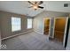 Spacious bedroom featuring neutral walls, carpet floors, walk-in closet, and a ceiling fan at 6157 Winthrop Ave, Indianapolis, IN 46220