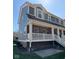 Beautiful two-story brick townhome with a spacious elevated porch and appealing architectural details at 6157 Winthrop Ave, Indianapolis, IN 46220