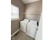 Convenient laundry room with a washer, dryer, and ample shelving for storage at 6157 Winthrop Ave, Indianapolis, IN 46220