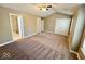 Spacious main bedroom boasts vaulted ceiling, plush carpet, and double door closets at 6157 Winthrop Ave, Indianapolis, IN 46220