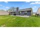 Spacious backyard featuring a well-maintained lawn, patio, and privacy fence, ideal for outdoor activities and entertaining at 6159 Connie Ct, Indianapolis, IN 46237