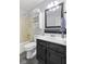 Bathroom with vanity, updated fixtures, tiled walls, and shower and tub combo at 6159 Connie Ct, Indianapolis, IN 46237