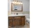 Cozy bathroom features a single sink vanity, neutral-toned walls, and a large mirror with an ornate gold frame at 6159 Connie Ct, Indianapolis, IN 46237