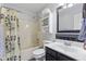 Updated bathroom featuring black and white tile, shower and tub, and ample storage at 6159 Connie Ct, Indianapolis, IN 46237