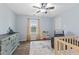 Bright bedroom with wood floors, neutral walls, ceiling fan, and ample sunlight at 6159 Connie Ct, Indianapolis, IN 46237