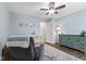 Cozy Bedroom with blue walls, ceiling fan, wood floors, and an area rug at 6159 Connie Ct, Indianapolis, IN 46237