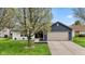 Charming home with blue siding, neutral garage door, and a beautifully landscaped front yard at 6159 Connie Ct, Indianapolis, IN 46237